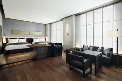 a bedroom with a bed and a table and chairs at AC Hotel by Marriott Tokyo Ginza in Tokyo