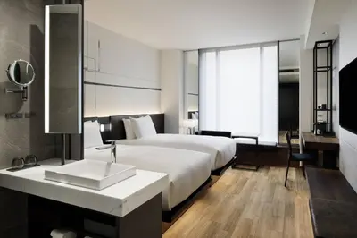 a hotel room with a bed and a sink at AC Hotel by Marriott Tokyo Ginza in Tokyo