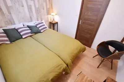 a bedroom with a bed with yellow sheets and a chair at Hikifune Kodate - Vacation STAY 8861 in Tokyo