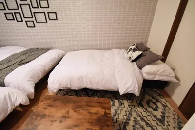 a bedroom with a bed with white pillows on it at Hikifune Kodate - Vacation STAY 8861 in Tokyo
