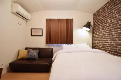 a bedroom with a large bed and a couch at Hikifune Kodate - Vacation STAY 8861 in Tokyo