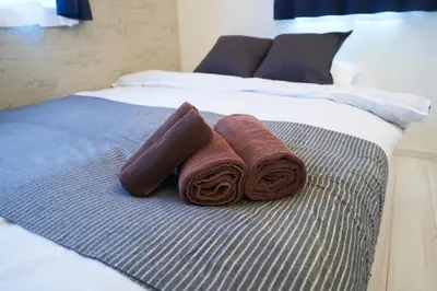 two towels sitting on top of a bed at Kitaikebukuro Kodate - Vacation STAY 8854 in Tokyo