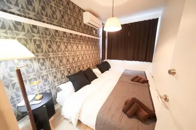 a bedroom with a bed and a brick wall at Kitaikebukuro Kodate - Vacation STAY 8854 in Tokyo
