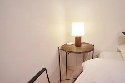 a lamp on a side table next to a bed at Kitaikebukuro Kodate - Vacation STAY 8854 in Tokyo