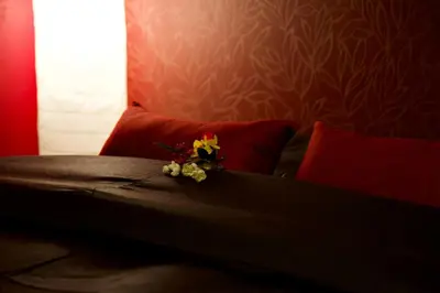 a bed with red pillows with a flower on it at Mukojima Kodate - Vacation STAY 8857 in Tokyo