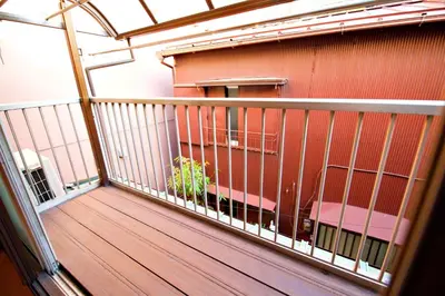 a balcony with a wooden deck and a building at Mukojima Kodate - Vacation STAY 8857 in Tokyo