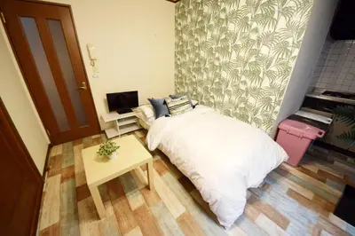a small bedroom with a bed and a table at Ikebukuro Kodate - Vacation STAY 8859 in Tokyo