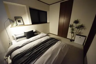 a bedroom with a large bed with a window at Ikebukuro Kodate - Vacation STAY 8859 in Tokyo