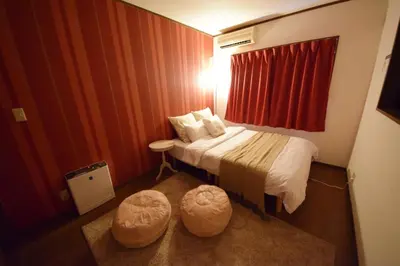 a hotel room with a bed with two ottomans at Ikebukuro Kodate - Vacation STAY 8859 in Tokyo