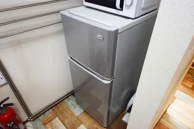 a small refrigerator with a microwave on top of it at Ikebukuro Kodate - Vacation STAY 8859 in Tokyo