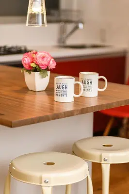 two coffee mugs sitting on a counter with two stools at Horikiri Kodate - Vacation STAY 8860 in Tokyo