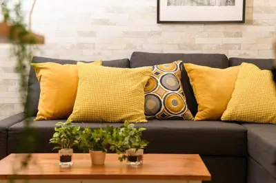 a couch with yellow pillows and a coffee table at Horikiri Kodate - Vacation STAY 8860 in Tokyo