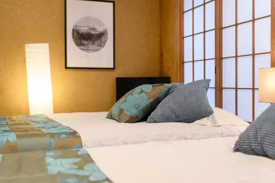 a bedroom with two beds and two windows at Horikiri Kodate - Vacation STAY 8860 in Tokyo