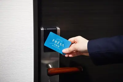 a person holding a blue card with the text free mail at Sotetsu Fresa Inn Kanda-Otemachi in Tokyo