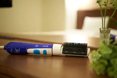 a blue and white toothbrush sitting on a table at Sotetsu Fresa Inn Kanda-Otemachi in Tokyo