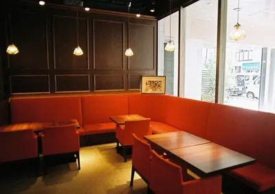 a restaurant with tables and chairs and a bench at Sotetsu Fresa Inn Kanda-Otemachi in Tokyo
