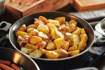 a pan filled with potatoes on top of a stove at Sotetsu Fresa Inn Kanda-Otemachi in Tokyo