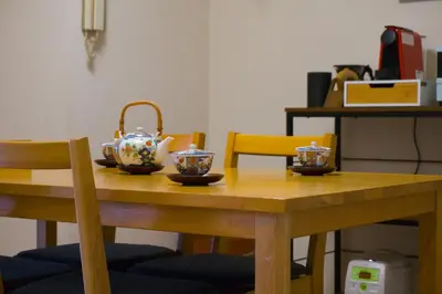 a wooden table with a tea pot and bowls on it at Yuyake in Tokyo