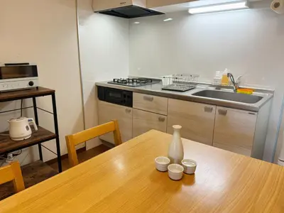 a kitchen with a wooden table and a sink at Yuyake in Tokyo