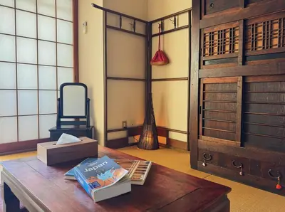a room with a table with books and a door at Yuyake in Tokyo