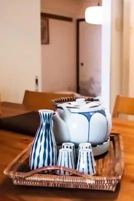 a table with blue and white vases on a tray at Nishi-Ikebukuro 3 in Tokyo