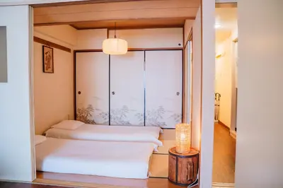 two beds in a room with a window at Nishi-Ikebukuro 3 in Tokyo