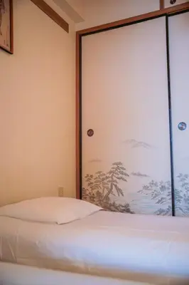 a bedroom with a bed and a large window at Nishi-Ikebukuro 3 in Tokyo
