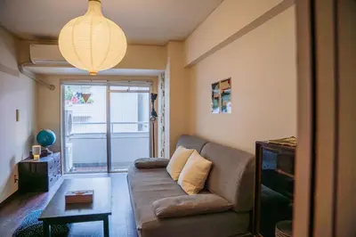 a living room with a couch and a table at Nishi-Ikebukuro 3 in Tokyo