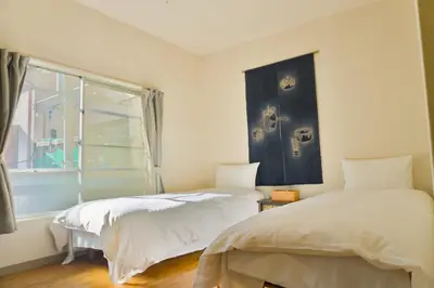 a bedroom with two beds and a window at Ikebukuro in Tokyo