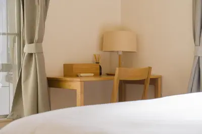 a bedroom with a desk with a lamp and a chair at Ikebukuro in Tokyo