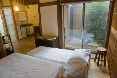 a bedroom with a bed and a large window at Ikebukuro Nigo in Tokyo