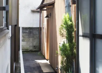 an alleyway between two buildings with a building at Ikebukuro Nigo in Tokyo