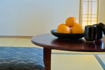 a bowl of oranges sitting on a table at Nishibi in Tokyo