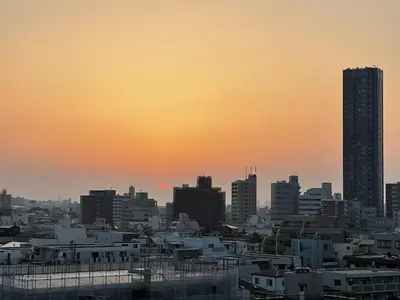 a view of a city skyline at sunset at Nishibi in Tokyo