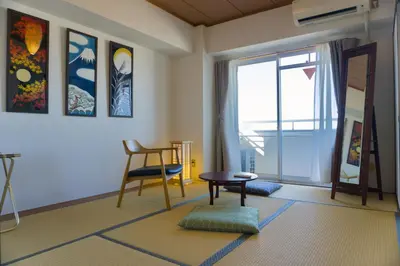 a living room with a table and a chair at Nishibi in Tokyo