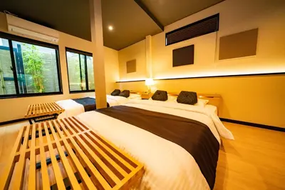 a bedroom with two beds and two windows at EAST ONE Higashishinjuku in Tokyo