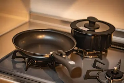 a pan on a stove with a pot on it at EAST ONE Higashishinjuku in Tokyo