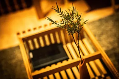 a wooden bench with a plant in it at EAST ONE Higashishinjuku in Tokyo
