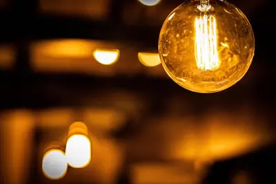 a glass light bulb hanging from a ceiling at EAST ONE Higashishinjuku in Tokyo