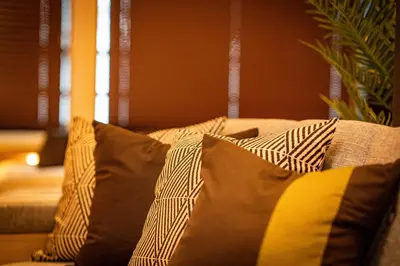 a couch with pillows on it in a living room at EAST ONE Higashishinjuku in Tokyo
