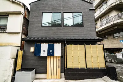 a house with a pair of towels hanging over the door at EAST ONE Higashishinjuku in Tokyo