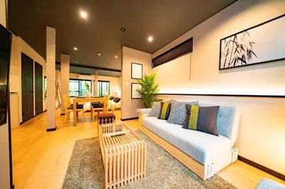 a living room with a couch and a table at EAST ONE Higashishinjuku in Tokyo