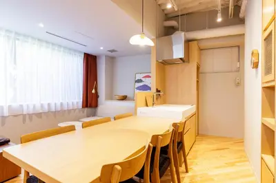 a kitchen with a large wooden table and a sink at tefu yoyogi uehara 101 - good design award - in Tokyo