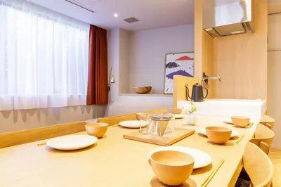a dining room with a table with plates and bowls on it at tefu yoyogi uehara 101 - good design award - in Tokyo