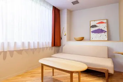 a living room with a bench and a window at tefu yoyogi uehara 101 - good design award - in Tokyo