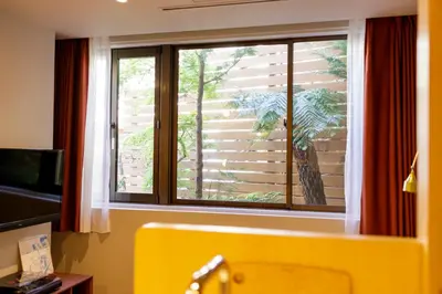 a window in a room with a yellow tub at tefu yoyogi uehara 101 - good design award - in Tokyo