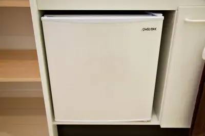 a white refrigerator in a white cabinet at R-Guest Residence \u6771\u4eac\u6d45\u8349 east2 in Tokyo