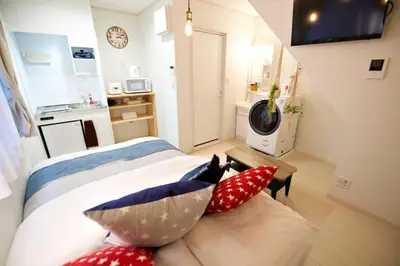 a bedroom with a bed with pillows on it at R-Guest Residence \u6771\u4eac\u6d45\u8349 east2 in Tokyo