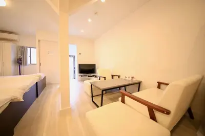 a bedroom with a bed and a table and chairs at \u30d4\u30e9\u30cd\u30cf\u30a6\u30b9 in Tokyo