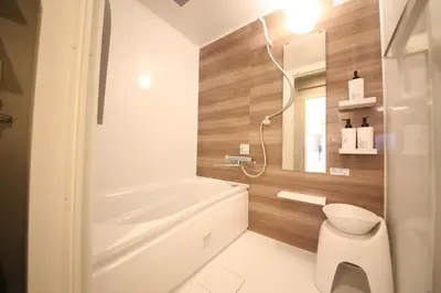 a bathroom with a tub and a toilet and a mirror at \u30d4\u30e9\u30cd\u30cf\u30a6\u30b9 in Tokyo